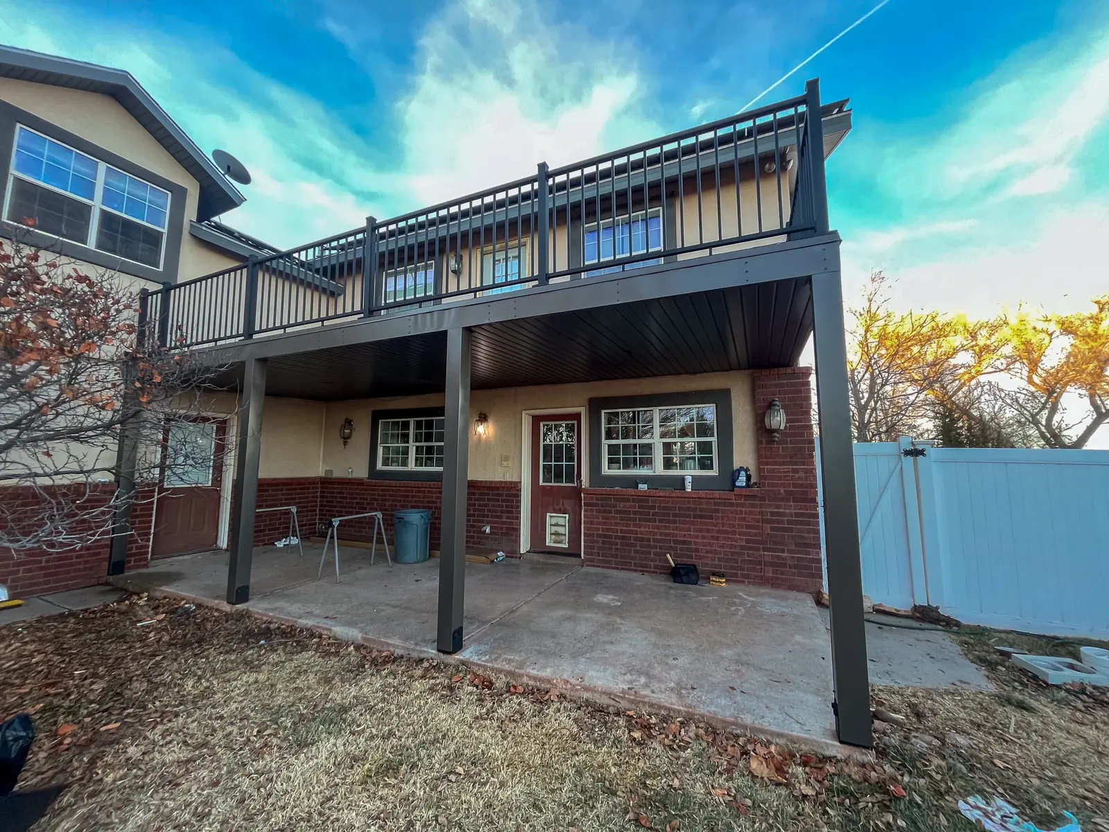 Raised timber deck and covered patio beside a two-storey house